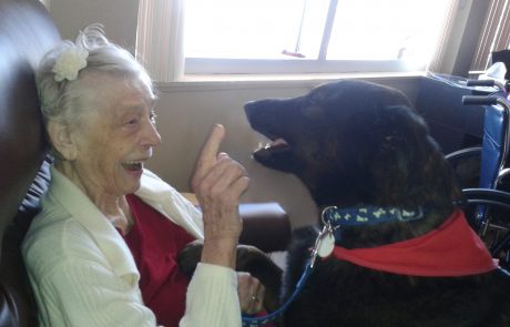 Older woman with black labrador retriever
