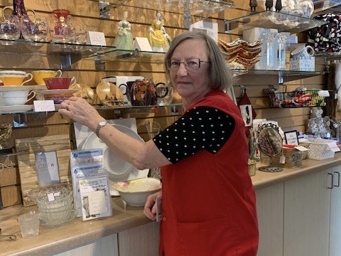 Mature hospital volunteer in gift shop